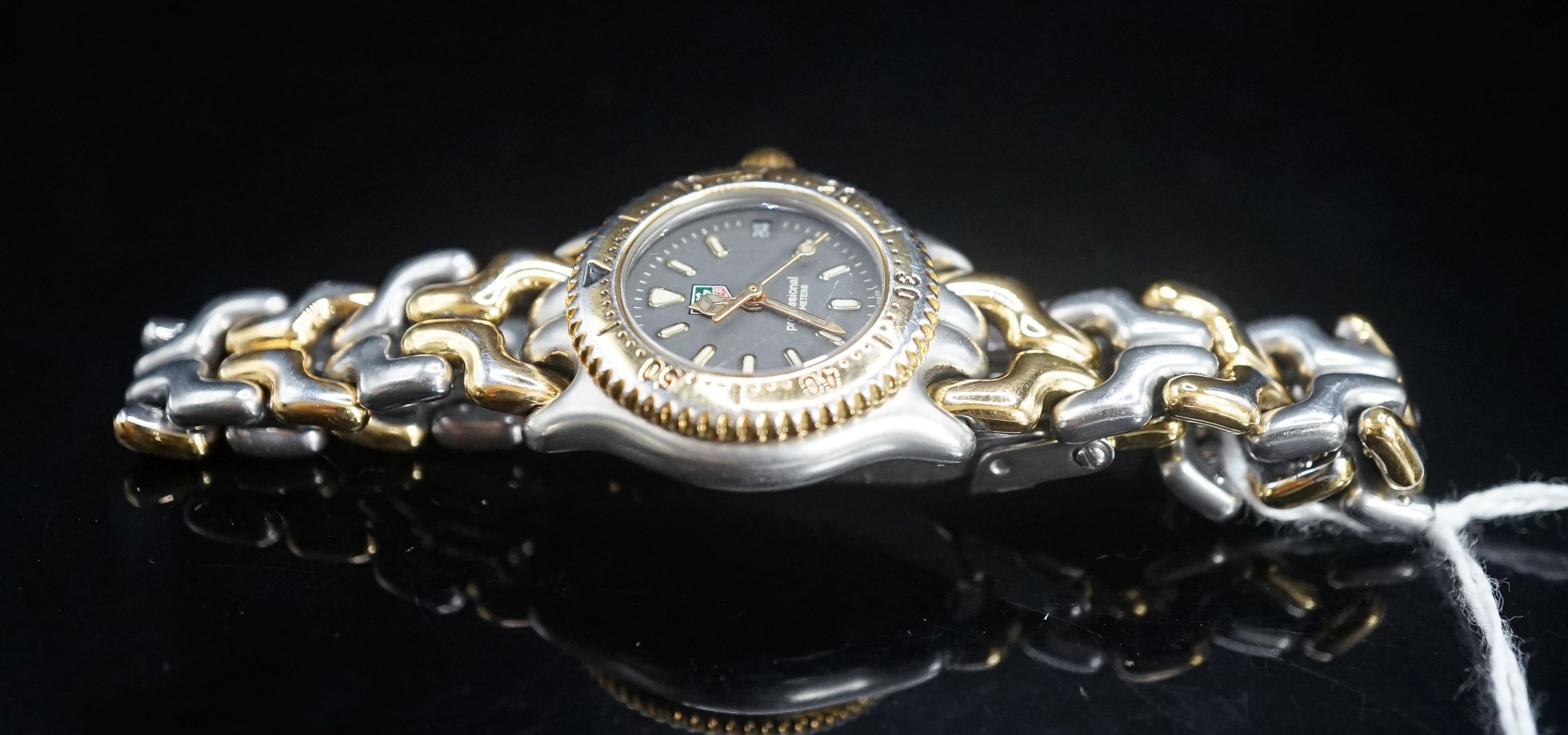 A lady's modern steel and gold plated Tag Heuer Professional quartz wrist watch, no box or papers.